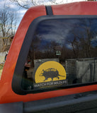 Yellow and black Watch for Wildlife decal on the back window of a car